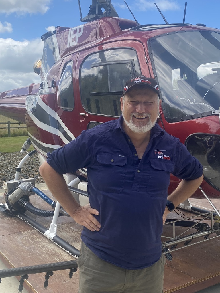 David Bramwell-Cooke beside a Tararua Heliwork helicopter